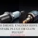Spark plug vs glow plug side by side comparison on workshop surface