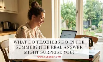 Teacher sitting at a sunny kitchen table in summer planning lessons and curriculum for the next school year with coffee and notebooks