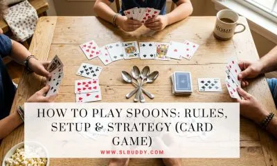 Spoons card game setup with four spoons and playing cards on a table