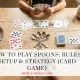 Spoons card game setup with four spoons and playing cards on a table